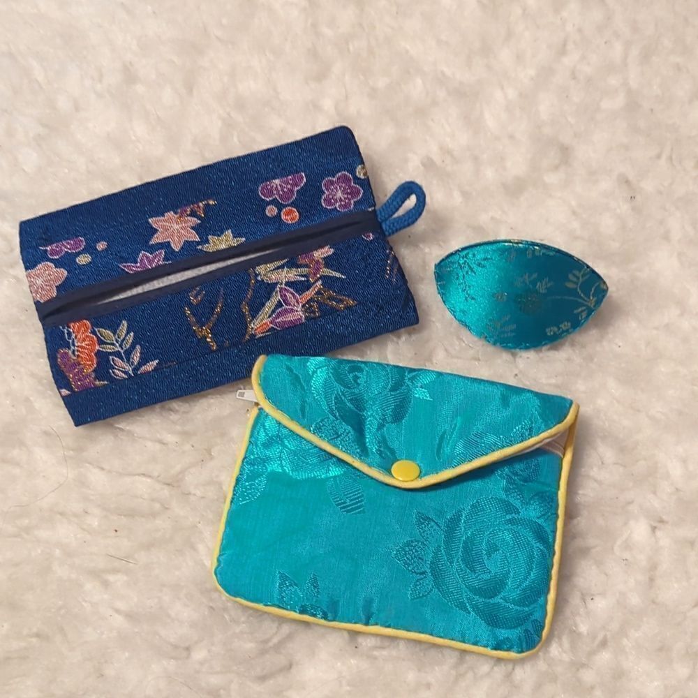 Three-piece Chinese fabric jewelry and accessory pouches.